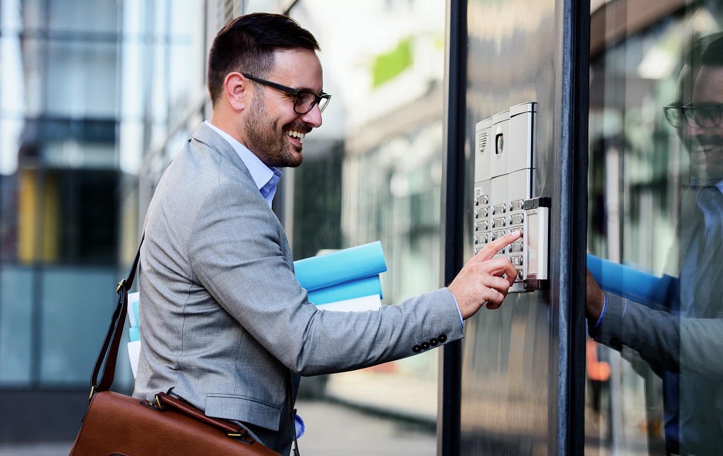 Businessman,Pushing,The,Button,And,Talking,On,The,Intercom,In